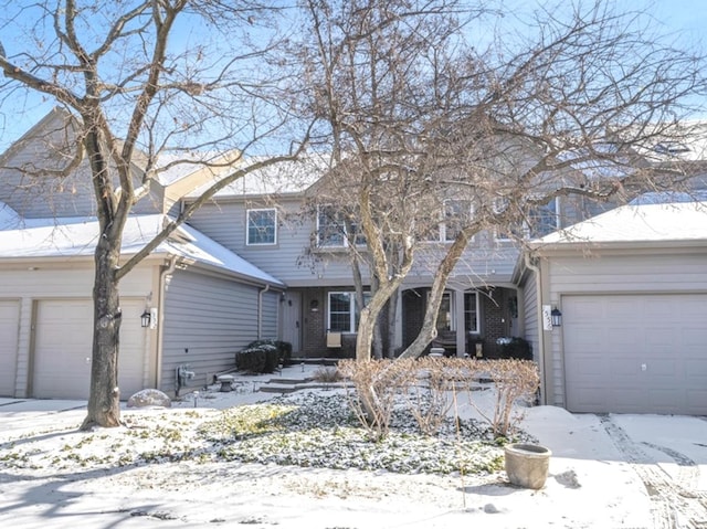 view of front of property with an attached garage and brick siding