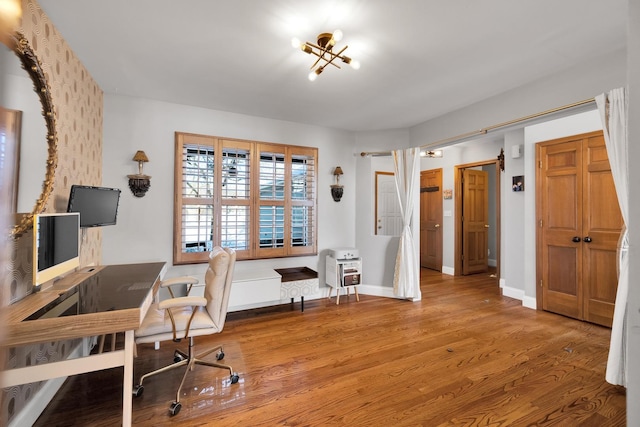 office space with baseboards and wood finished floors