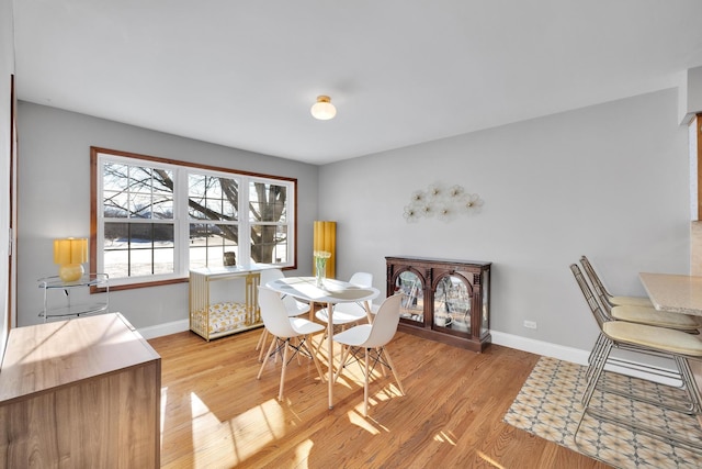 dining room featuring baseboards and wood finished floors