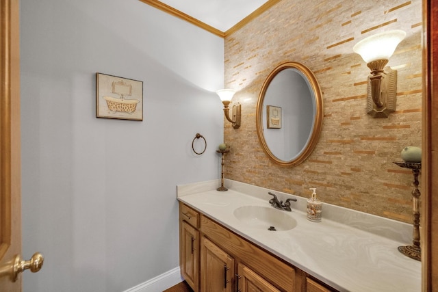 bathroom featuring baseboards, vanity, and crown molding