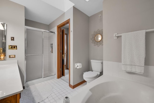 bathroom featuring a garden tub, toilet, vanity, baseboards, and a shower stall