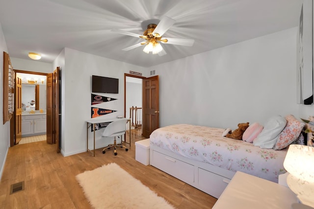 bedroom featuring a ceiling fan, light wood-type flooring, visible vents, and connected bathroom