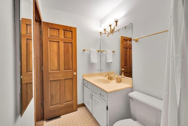 bathroom with visible vents, vanity, toilet, and tile patterned floors