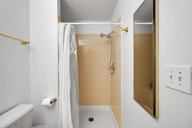 full bathroom with toilet and a shower stall