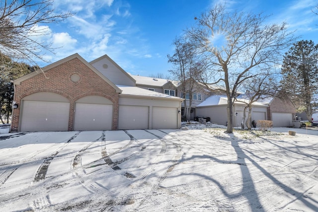 view of front of property with a garage and brick siding