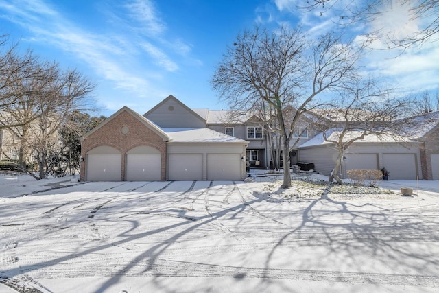 view of front of home featuring an attached garage and brick siding