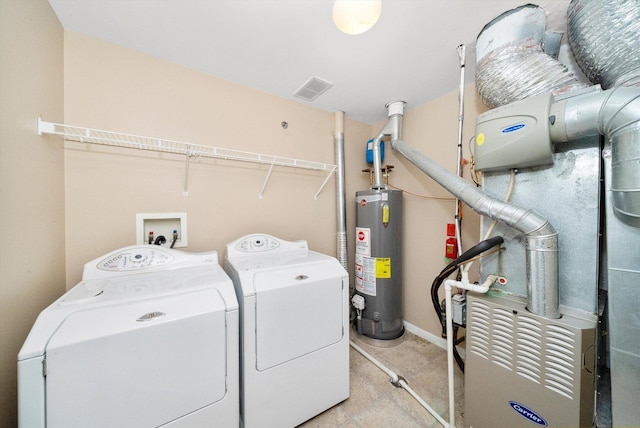 laundry room featuring laundry area, visible vents, washer and dryer, and gas water heater