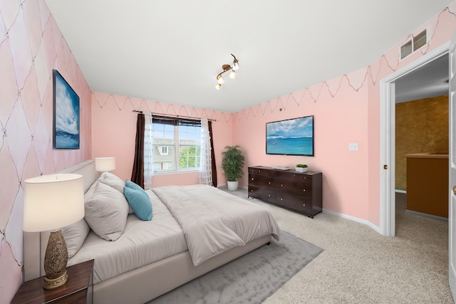 bedroom featuring baseboards, carpet flooring, visible vents, and wallpapered walls