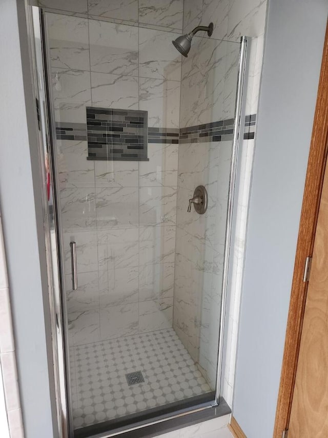 bathroom with a shower stall