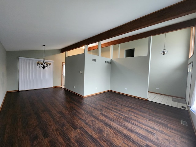 empty room featuring lofted ceiling with beams, visible vents, a chandelier, and wood finished floors