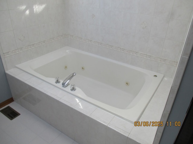 full bathroom featuring a tub with jets, visible vents, and tile patterned floors