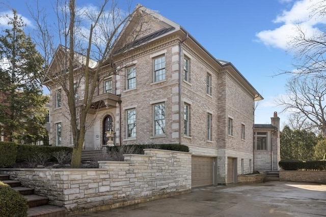 view of front facade featuring a garage, brick siding, and driveway