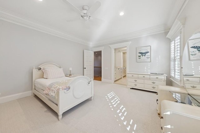 bedroom with ensuite bath, carpet, crown molding, baseboards, and ceiling fan