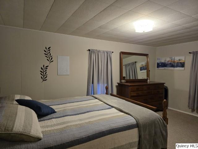 bedroom with carpet flooring and baseboards