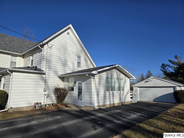 view of home's exterior featuring a garage and an outdoor structure