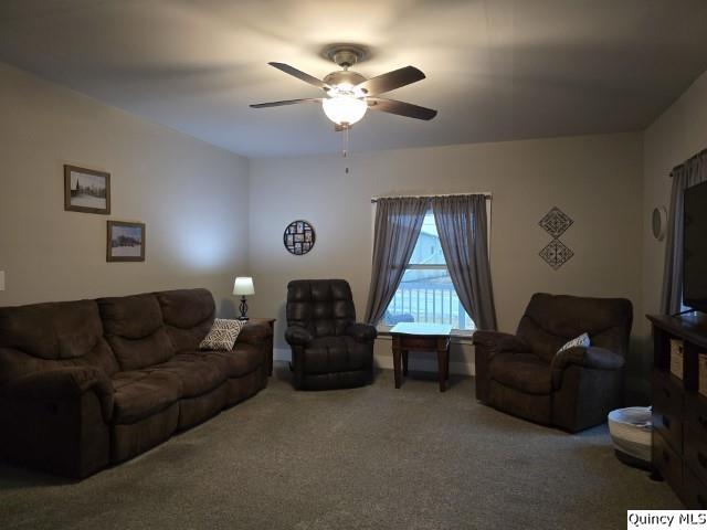 living room with carpet floors and ceiling fan