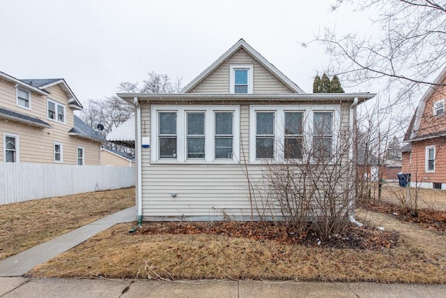 bungalow-style house with fence