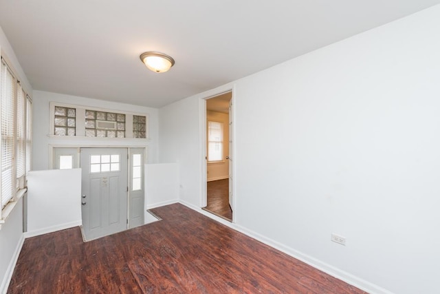 entrance foyer featuring baseboards and wood finished floors