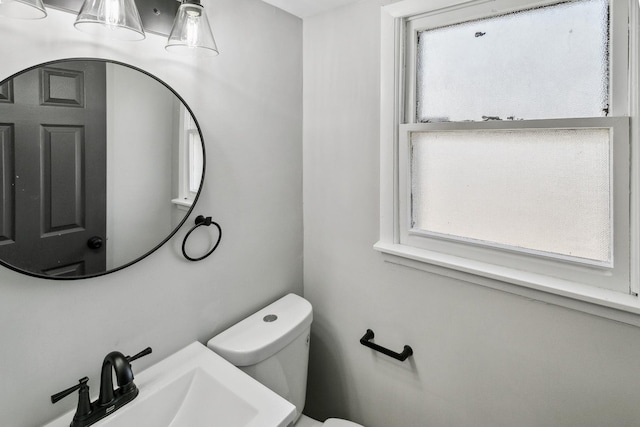 half bath featuring a sink and toilet