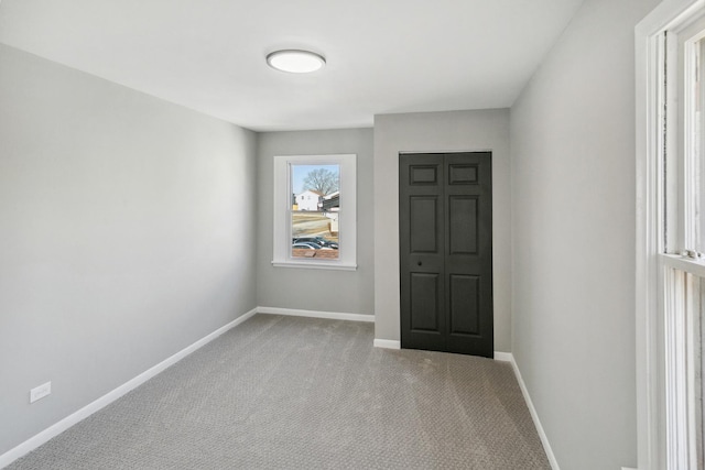 carpeted entrance foyer with baseboards