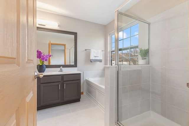 full bathroom featuring tile patterned floors, vanity, a shower stall, and a bath