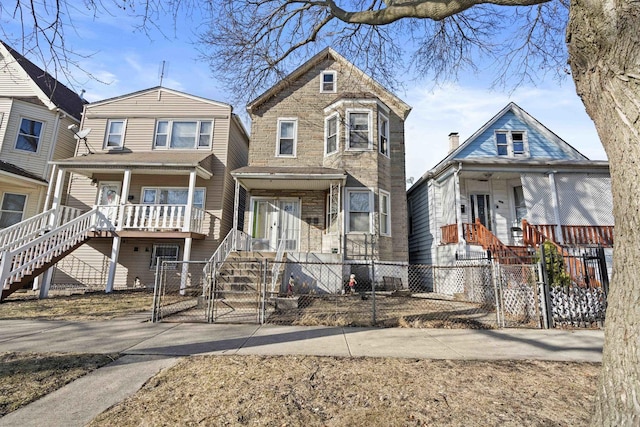 view of front facade featuring a porch, a gate, and a fenced front yard