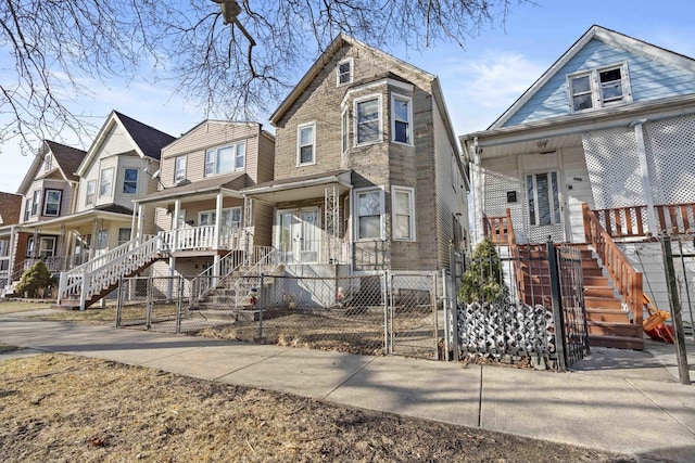 view of front facade with a fenced front yard, a porch, and a gate