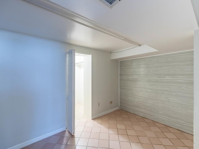 unfurnished room featuring baseboards and visible vents