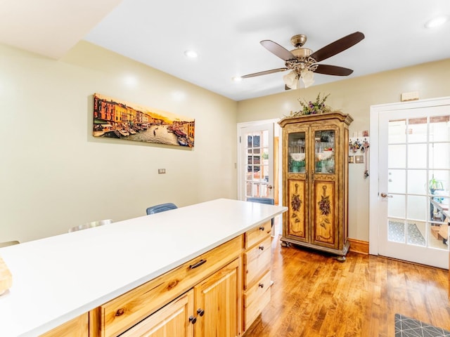 kitchen with light wood finished floors, recessed lighting, light countertops, a ceiling fan, and light brown cabinets