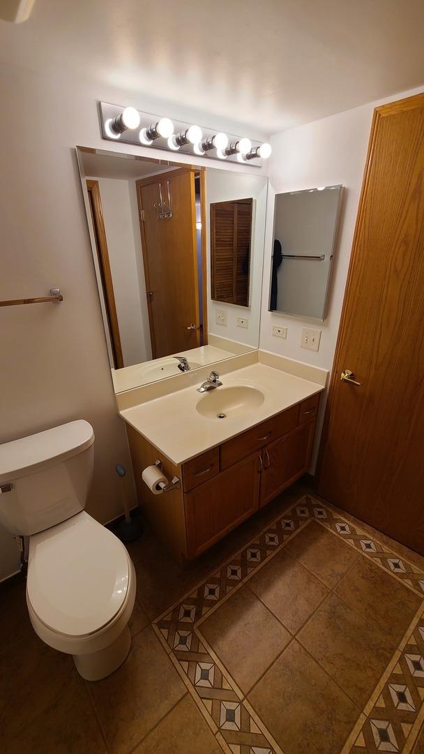 bathroom featuring vanity, toilet, and tile patterned floors