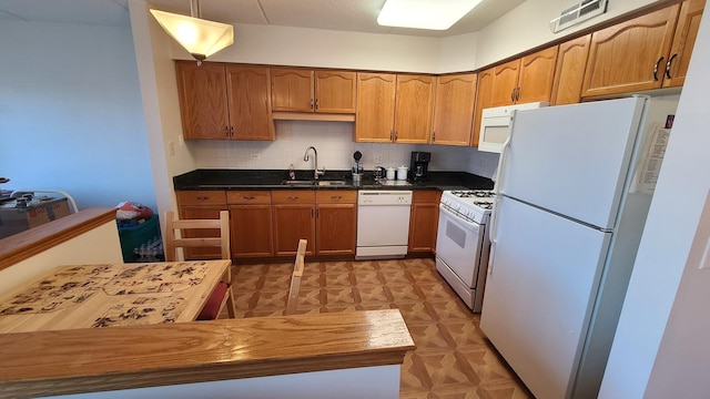 kitchen with white appliances, a sink, visible vents, backsplash, and light floors