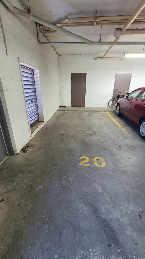 parking deck featuring concrete block wall