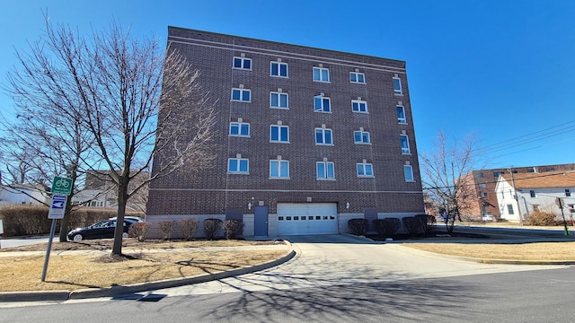 view of building exterior with a garage and driveway