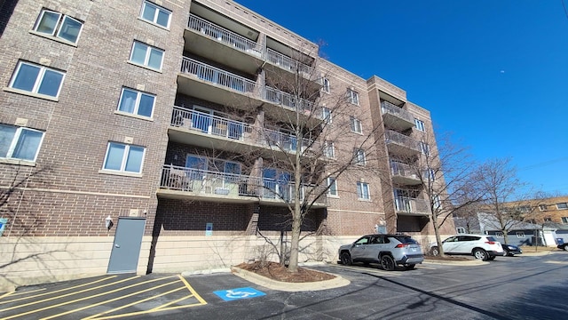 view of building exterior featuring uncovered parking