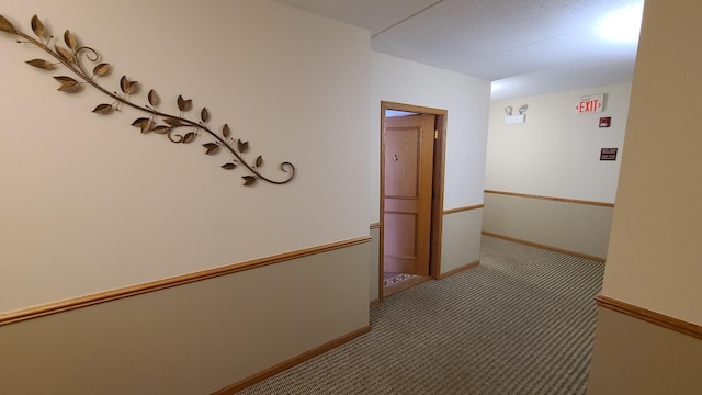 hallway with carpet and baseboards