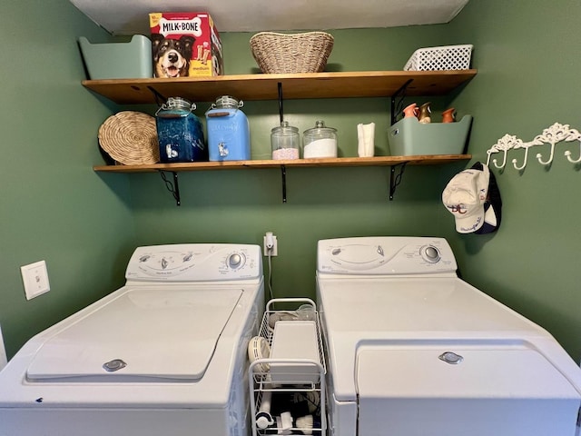 laundry area with washing machine and clothes dryer and laundry area