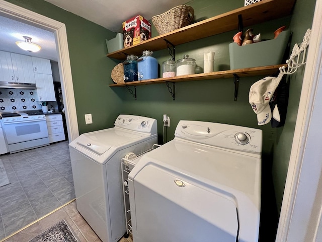 clothes washing area with separate washer and dryer and laundry area