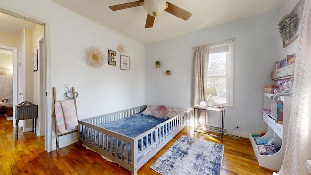 bedroom with ceiling fan, baseboards, and hardwood / wood-style floors