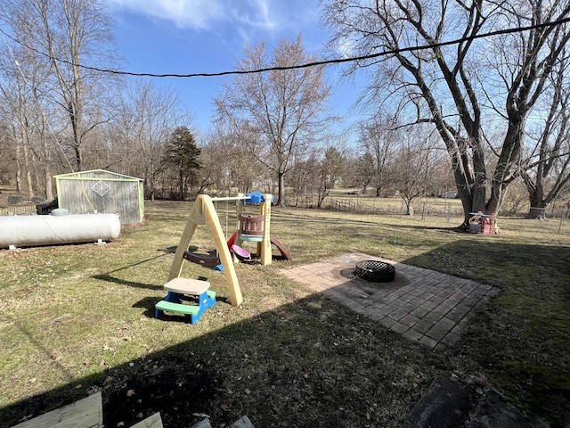 view of yard with an outdoor fire pit and a playground