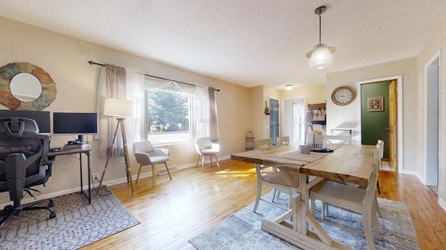 dining space featuring visible vents, light wood-type flooring, and baseboards