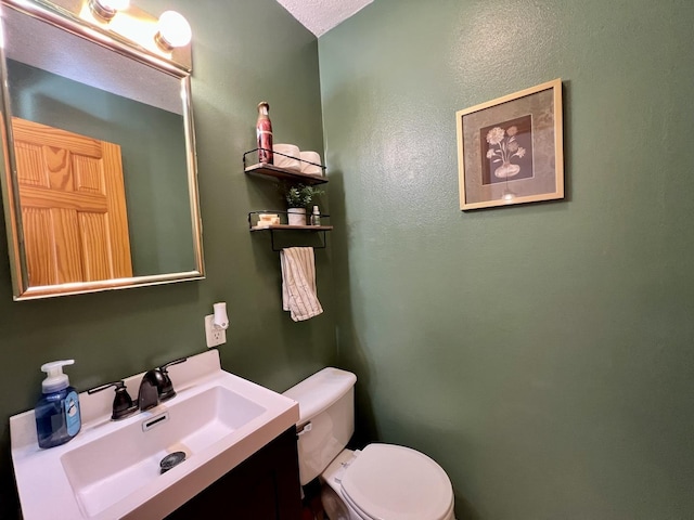 bathroom with toilet and vanity