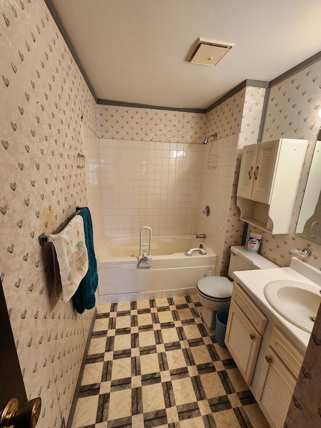 bathroom featuring  shower combination, wallpapered walls, toilet, and vanity