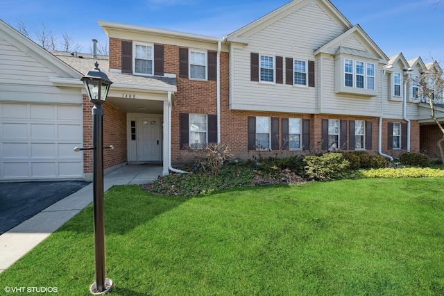 view of property with driveway, brick siding, a front lawn, and an attached garage