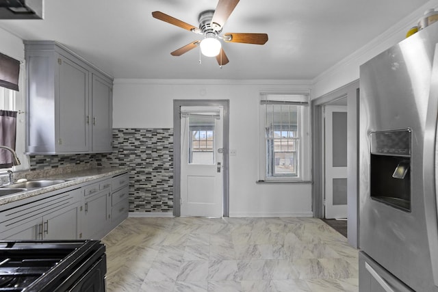 kitchen featuring gray cabinets, ornamental molding, a sink, ceiling fan, and stainless steel fridge