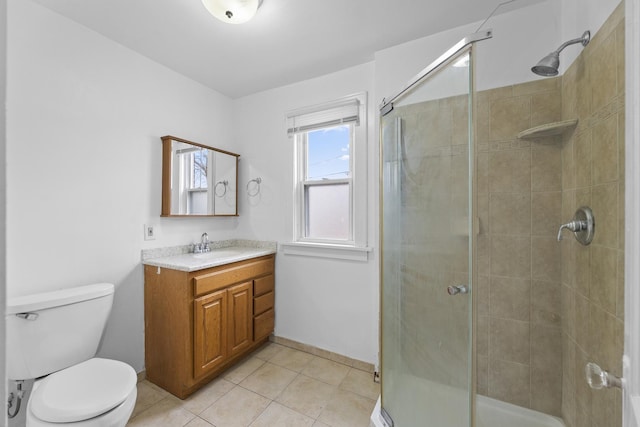 bathroom featuring a stall shower, vanity, toilet, and tile patterned floors