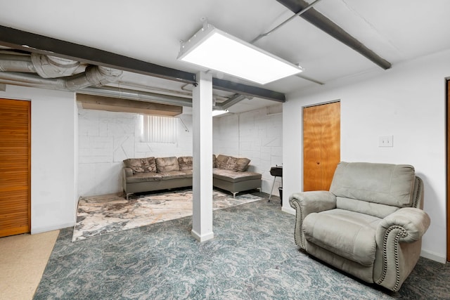 finished basement featuring concrete block wall and baseboards