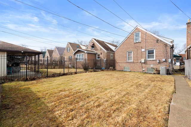 exterior space with brick siding, a lawn, fence, and central air condition unit