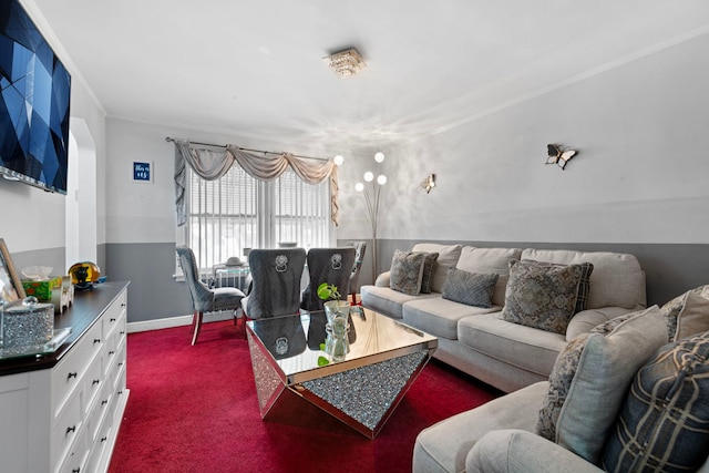 carpeted living room featuring baseboards and ornamental molding