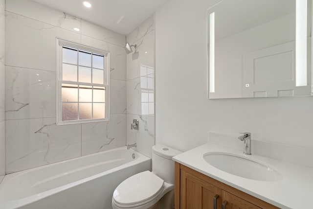 bathroom featuring tub / shower combination, vanity, and toilet