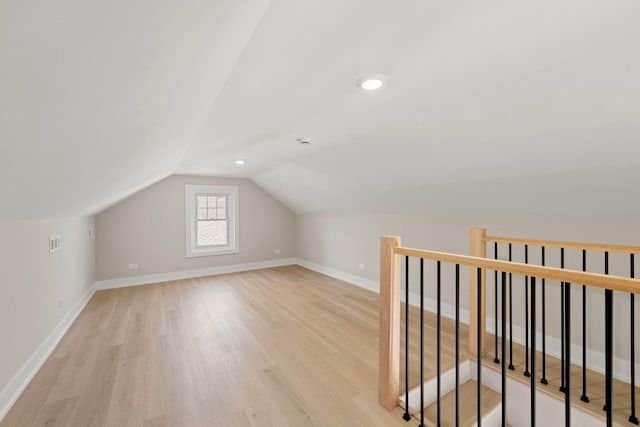 bonus room with light wood-style floors, baseboards, vaulted ceiling, and recessed lighting